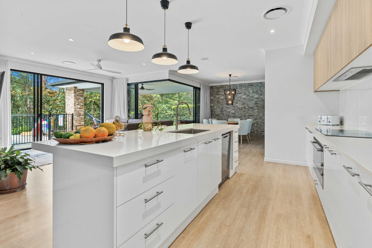 Modern open-plan kitchen overlooking the living area and outdoor entertaining space in a Gold Coast investment property.
