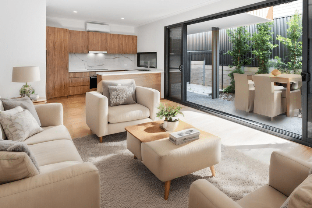 Modern investment property featuring an open-plan living area and kitchen with sliding doors opening to a private outdoor entertaining area.